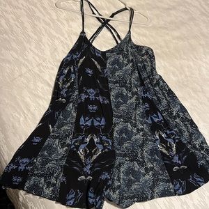 FreePeople’s Isabela blue romper dress with adjustable straps & side ties.